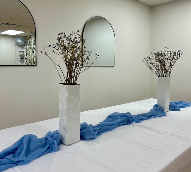 Long table styled with dried flowers and a blue runner