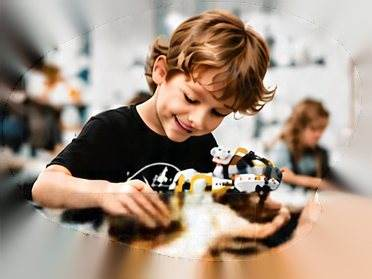 Child building a robot in a hands-on class